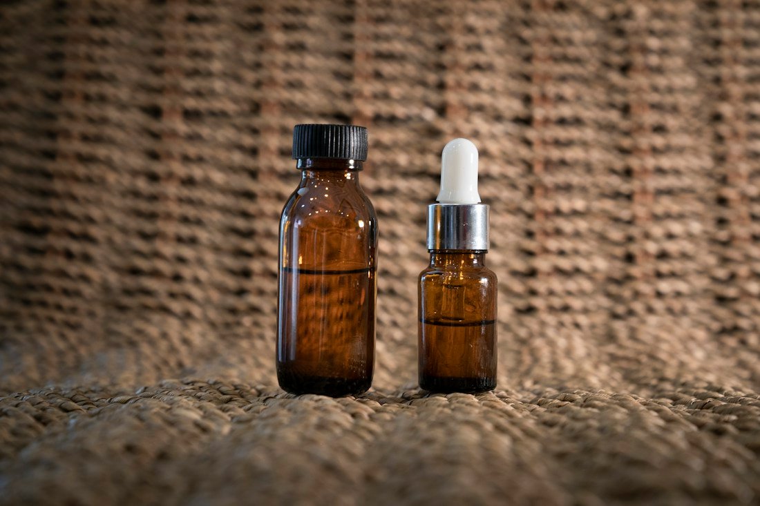 Amber skincare bottles arranged as a clean product still life